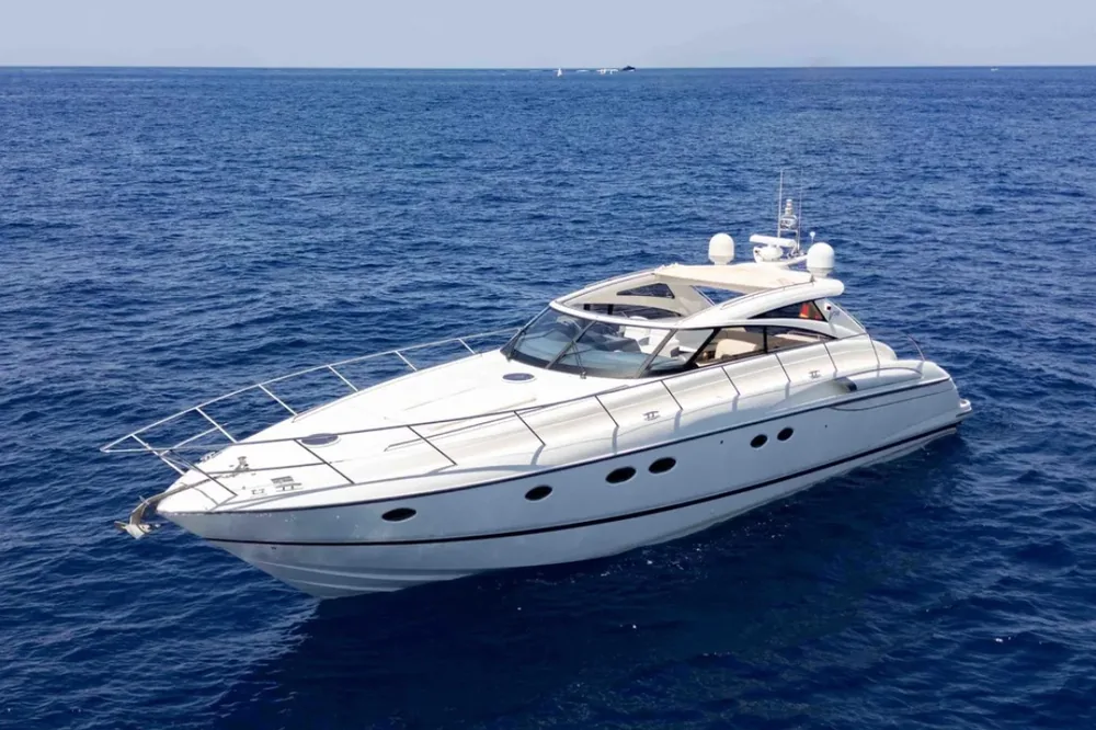 A white Princess V58 luxury motor yacht cruising on deep blue open water
